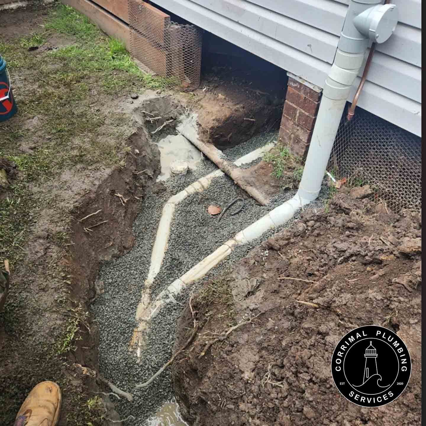 Plumbing Repair Outdoors Near a House Foundation — Corrimal Plumbing Services in East Corrimal, NSW