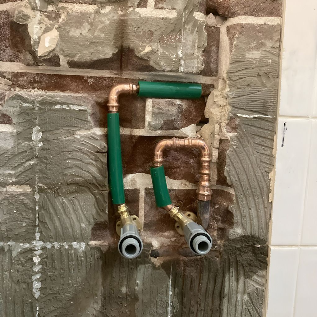 Two Green-Handled Copper Water Pipes With Faucet Connectors — Corrimal Plumbing Services in Bulli, NSW