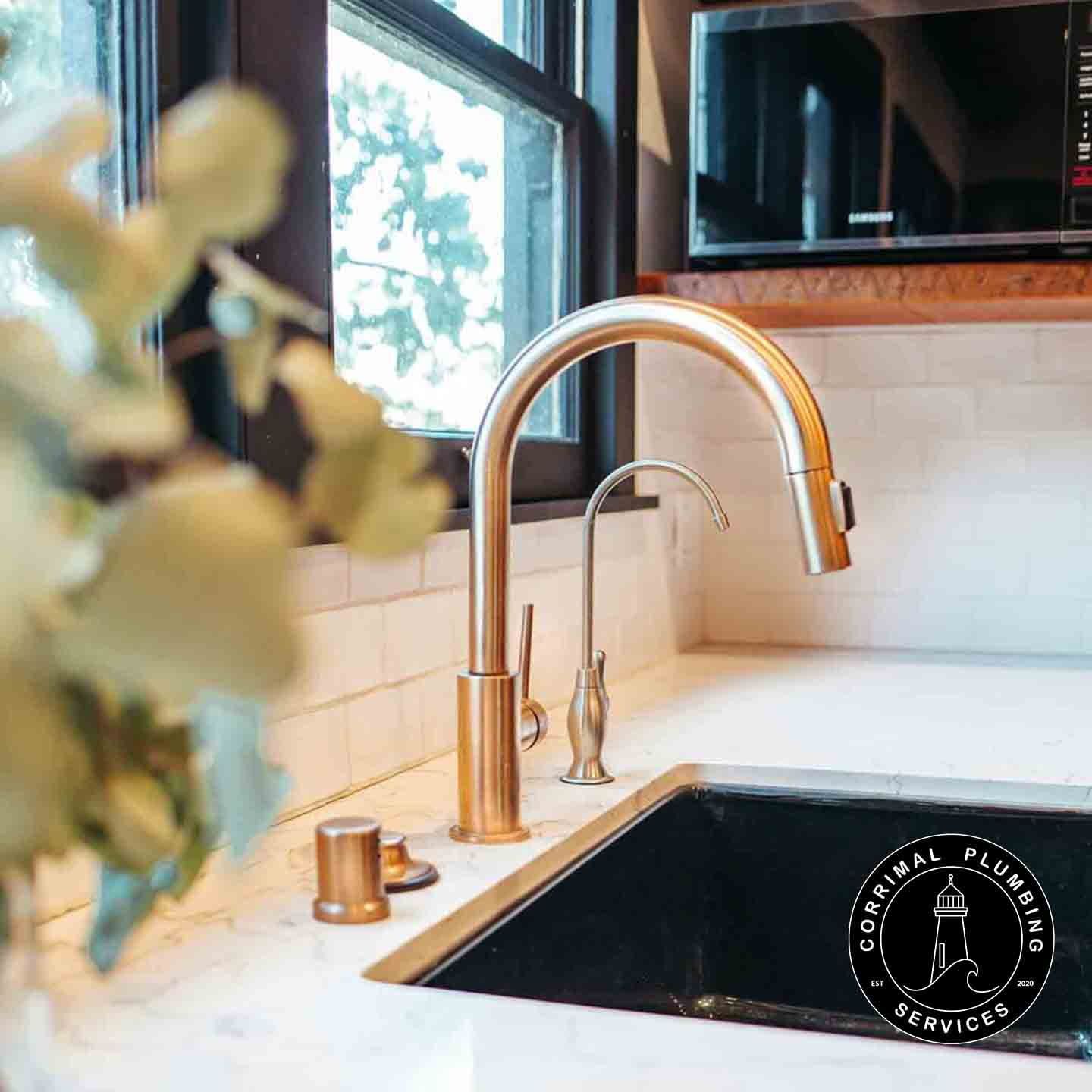 Golden Kitchen Faucet and Water Filter by Black Sink — Corrimal Plumbing Services in East Corrimal, NSW