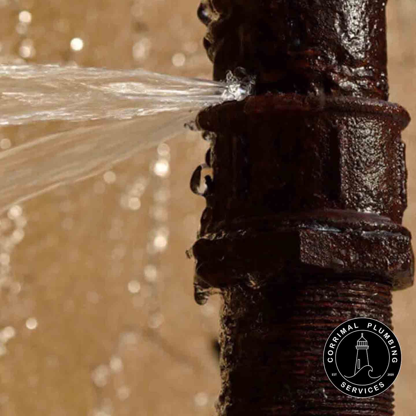 Rusty Pipe With a Leak, Water Spraying Out — Corrimal Plumbing Services in East Corrimal, NSW