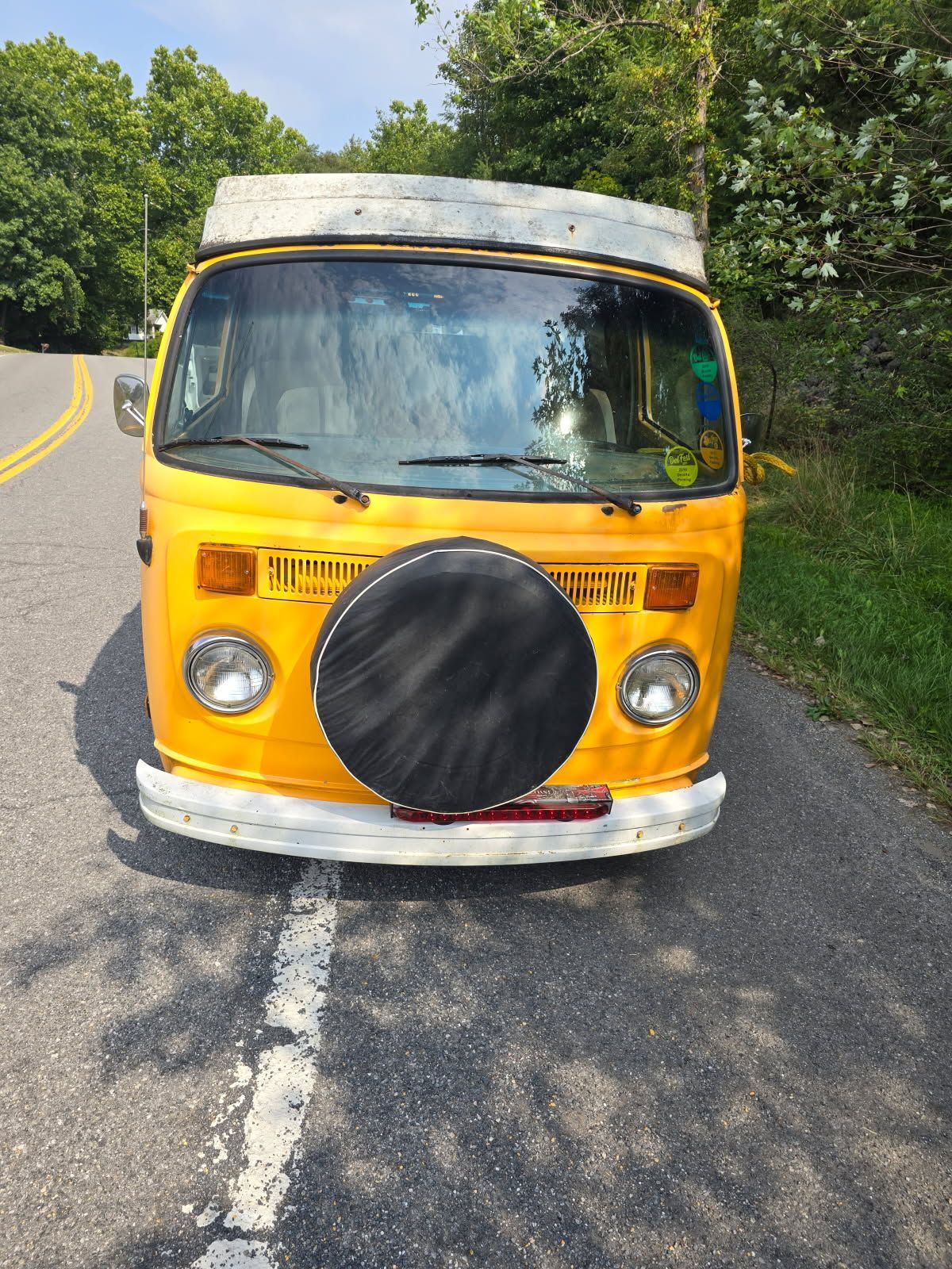 A yellow van is parked on the side of the road