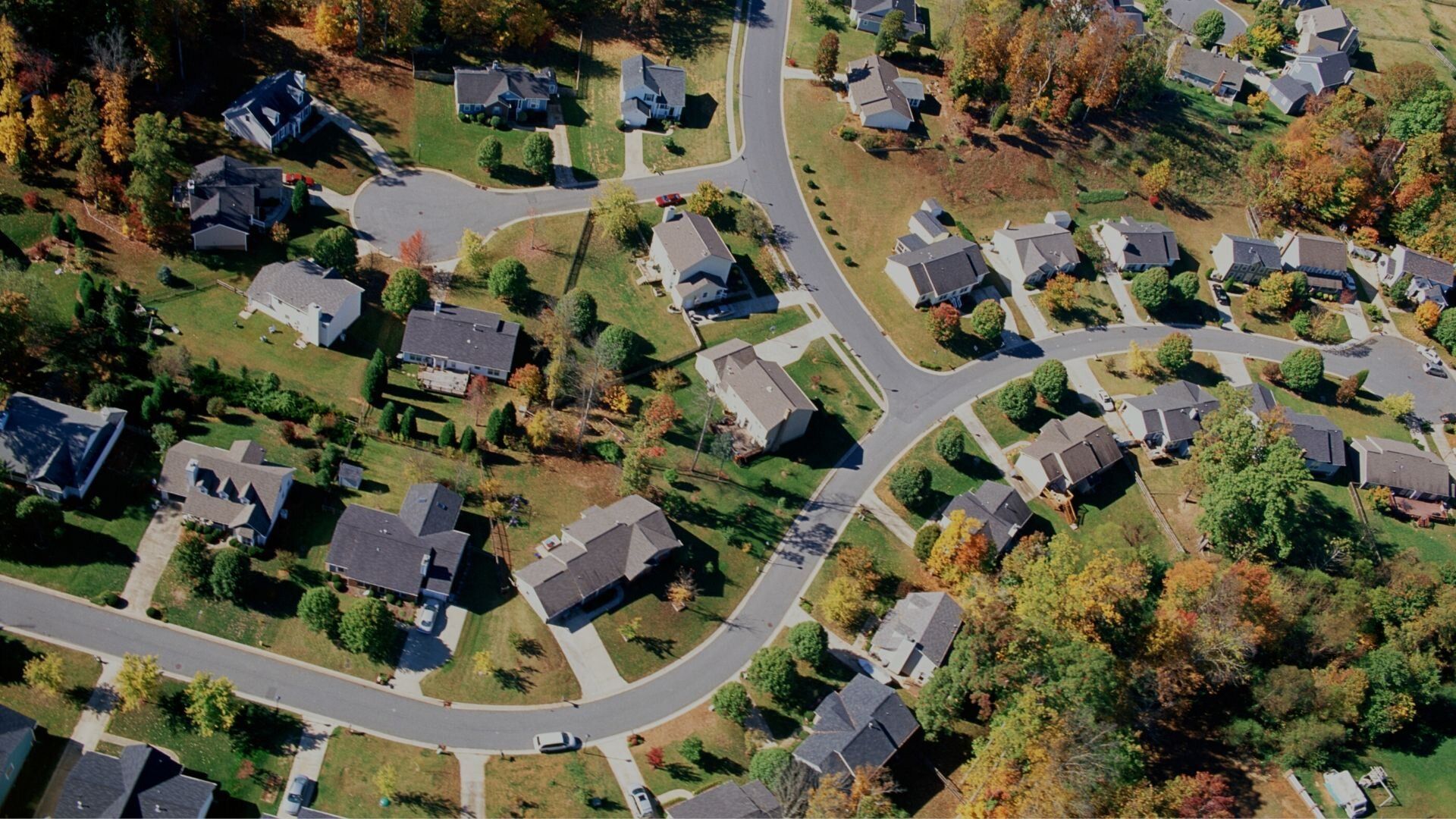An aerial view of a residential area with lots of houses and trees