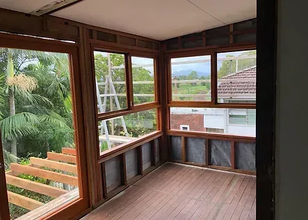 A Room With A Lot Of Windows And A Wooden Floor — Green e Building in Lennox Head, NSW