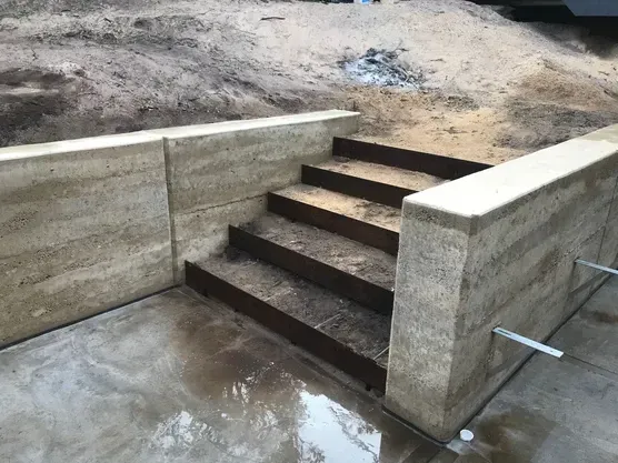A Set Of Stairs Leading Up To A Concrete Wall — Green e Building in Lennox Head, NSW