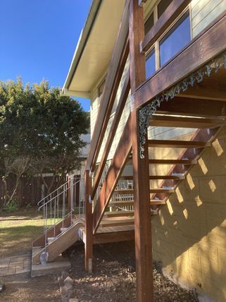 A Wooden Deck With Stairs Leading Up To A House — Green e Building in Lennox Head, NSW