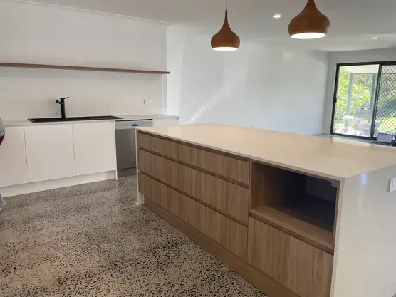 A Kitchen With A Large Island And A Sink — Green e Building in Lennox Head, NSW