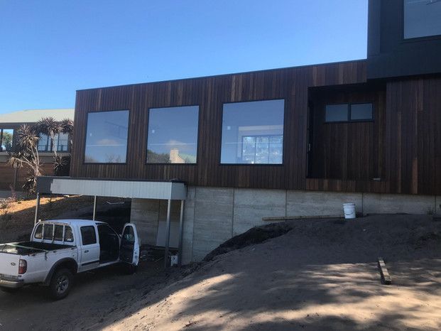A White Truck Is Parked In Front Of A Large Building — Green e Building in Lennox Head, NSW
