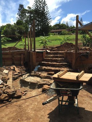 A Wheelbarrow Is Sitting On The Ground In Front Of A Building Under Construction — Green e Building in Lennox Head, NSW
