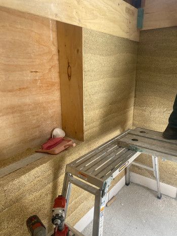 A Person Is Standing On A Ladder Next To A Bench In A Room — Green e Building in Lennox Head, NSW
