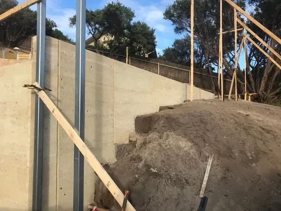 A Concrete Wall Is Being Built On Top Of A Pile Of Dirt — Green e Building in Lennox Head, NSW