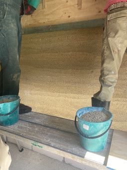 Two Buckets Of Sand Are Sitting On A Wooden Bench — Green e Building in Lennox Head, NSW