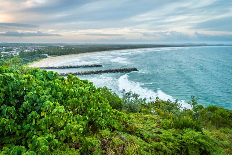 A View Of A Beach From A Cliff Overlooking The Ocean — Green e Building in Evans Head, NSW
