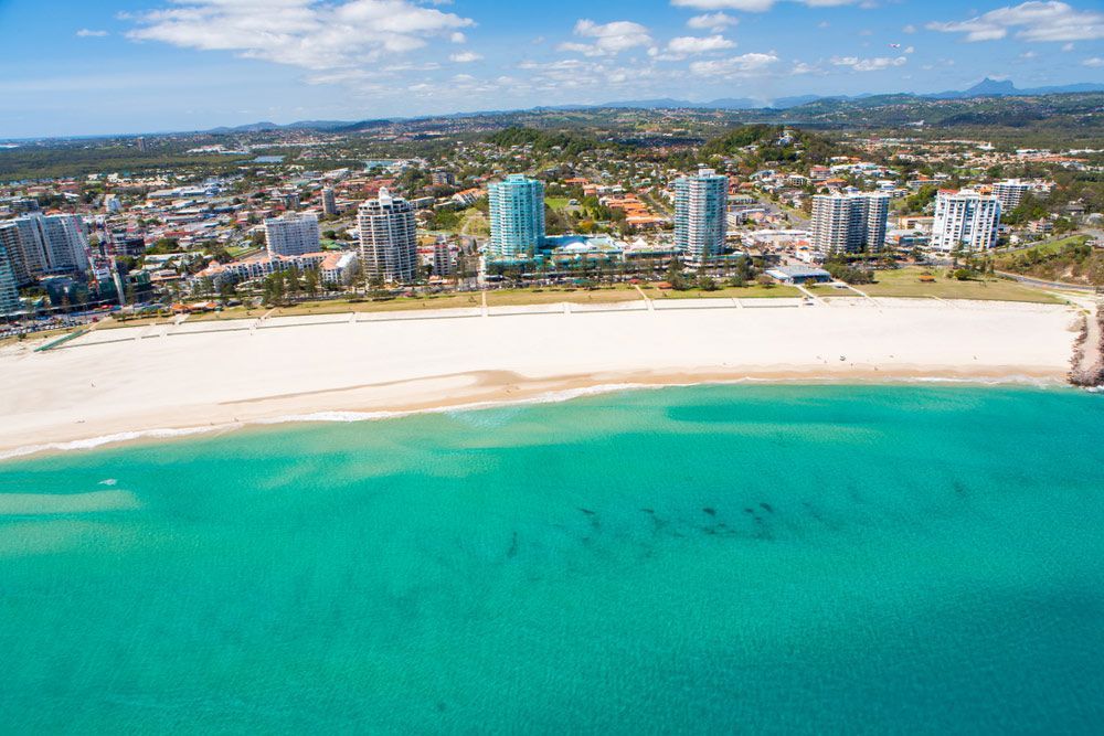 An Aerial View Of A Beach With A City In The Background 
— Green e Building in Gold Coast, QLD