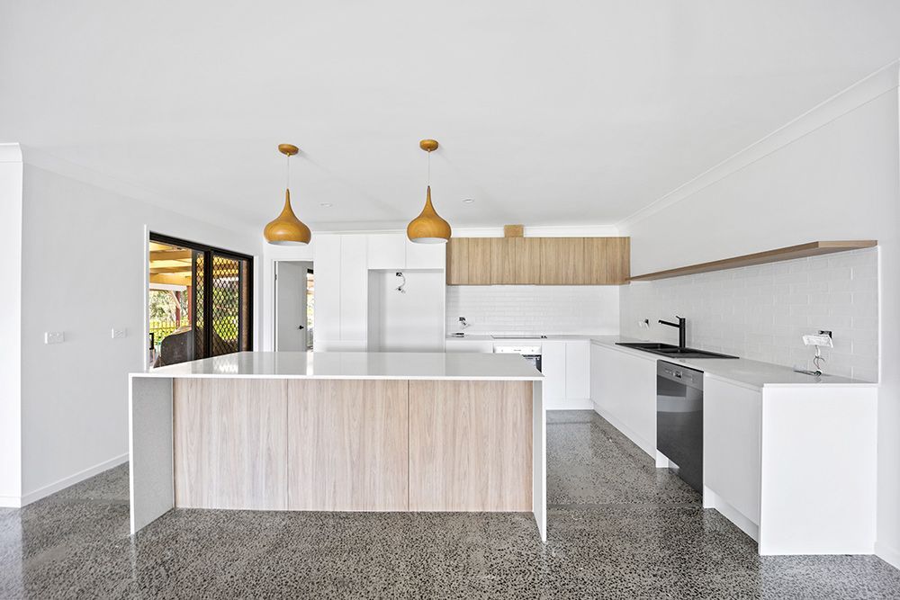 There Is A Large Island In The Middle Of The Kitchen — Green e Building in Kyogle, NSW