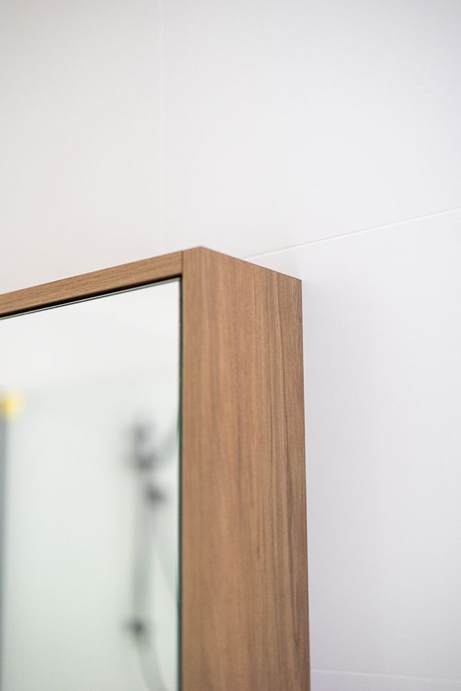 A Close Up Of A Wooden Cabinet With A Mirror On It — Green e Building in Lennox Head, NSW