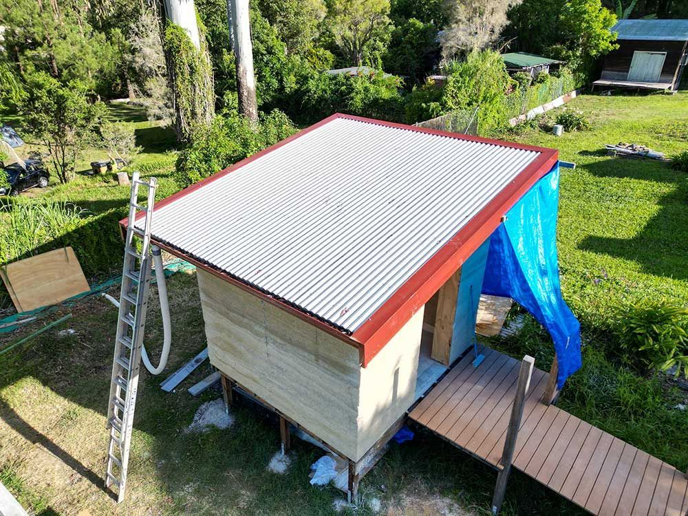 An Aerial View Of A Shed With A Corrugated Metal Roof — Green e Building in Byron Bay, NSW