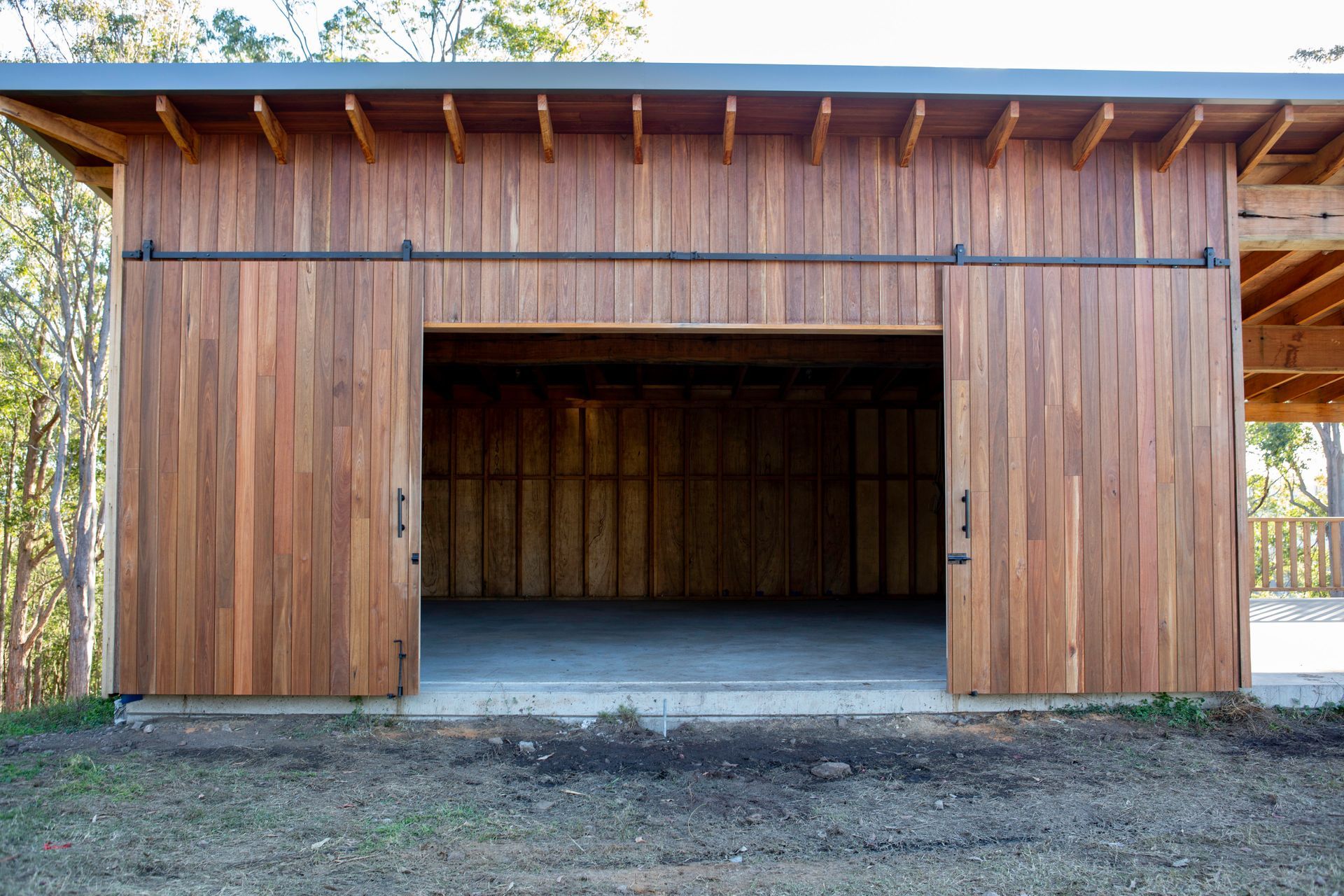 A Circular Saw Is Cutting A Log In A Factory — Green e Building in Byron Bay, NSW