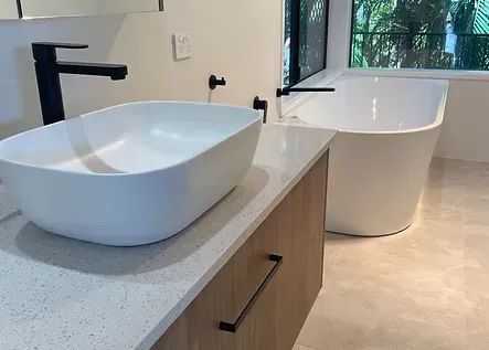 A Bathroom With Two Sinks And A Bathtub — Green e Building in Byron Bay, NSW