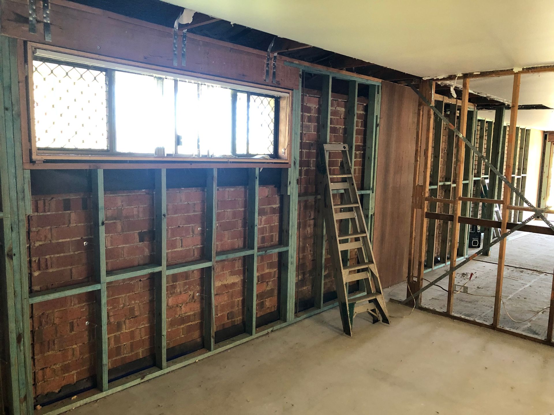 A Bathroom Sink With A Black Faucet And A Mirror — Green e Building in Lennox Head, NSW