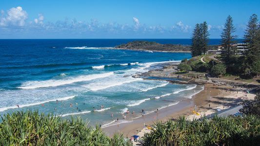 An Aerial View Of A Beach With Waves Crashing On The Shore — Green e Building in Yamba, NSW