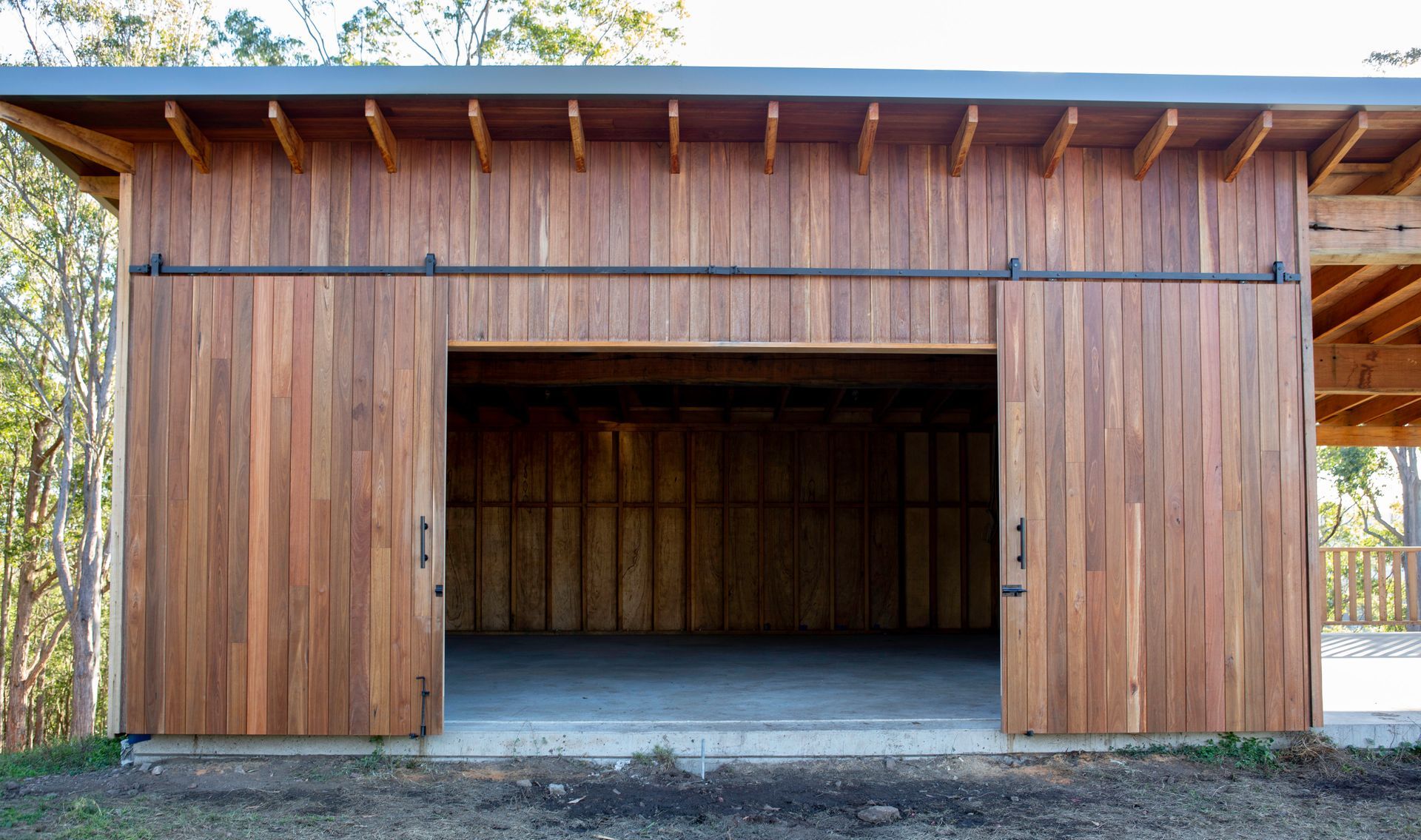 A Circular Saw Is Cutting A Log In A Factory — Green e Building in Lennox Head, NSW