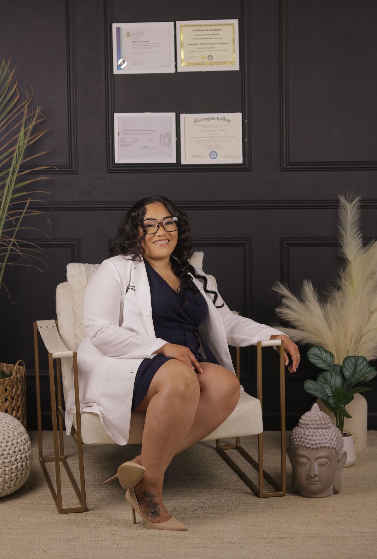 A woman in a lab coat is sitting in a chair.