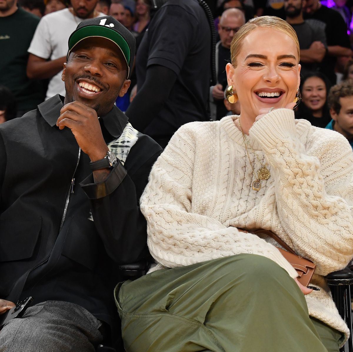 A man and a woman are sitting next to each other and smiling