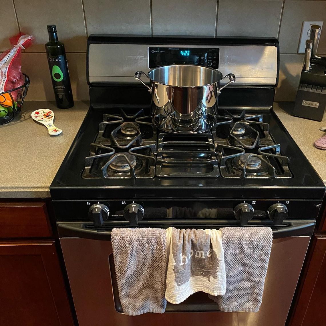 A stove top oven with a towel hanging from it