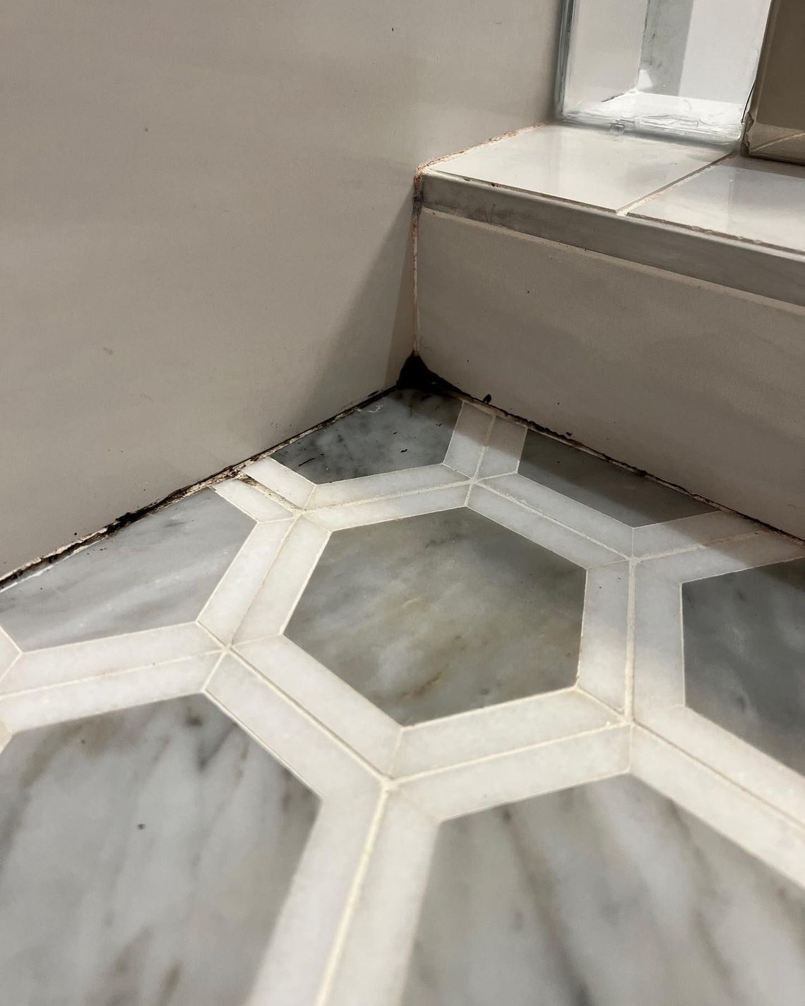 A close up of a tiled floor in a bathroom.
