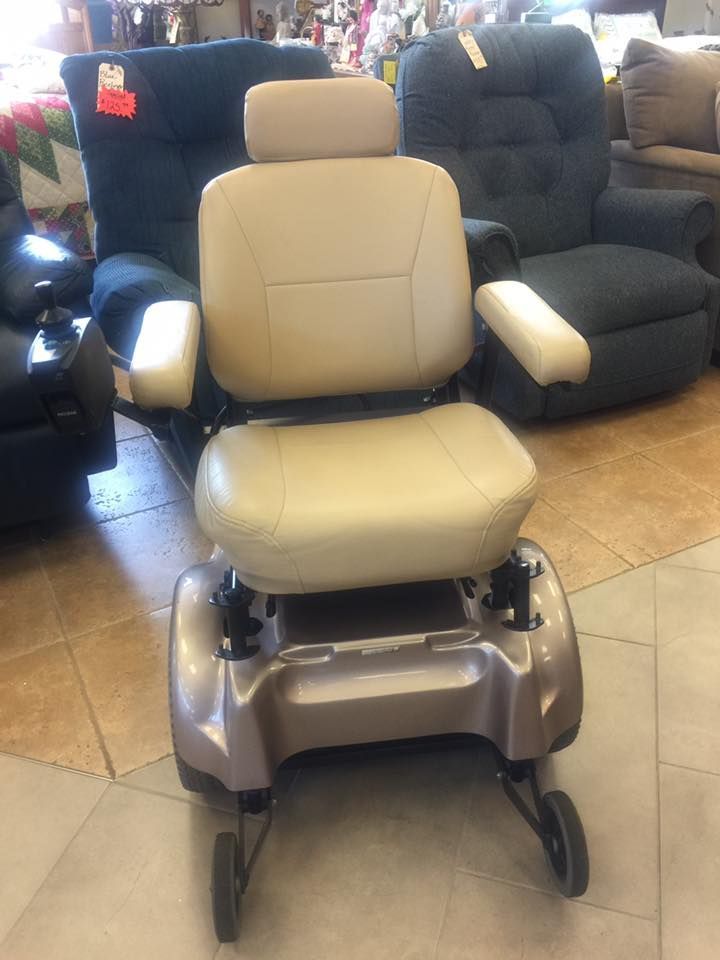 Two black wheelchairs are sitting next to each other on a tiled floor.