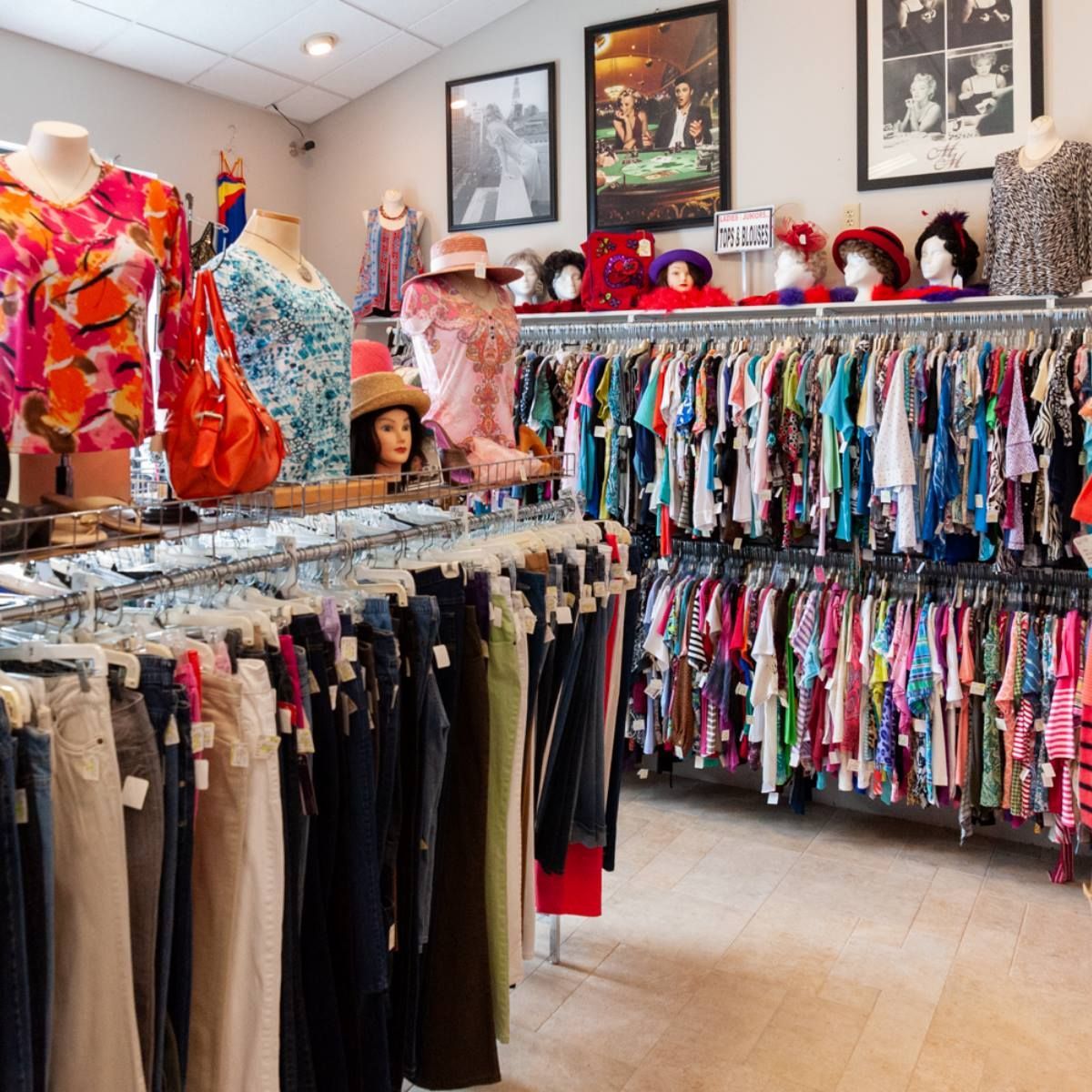 A bunch of halloween costumes are hanging on a rack in a store.