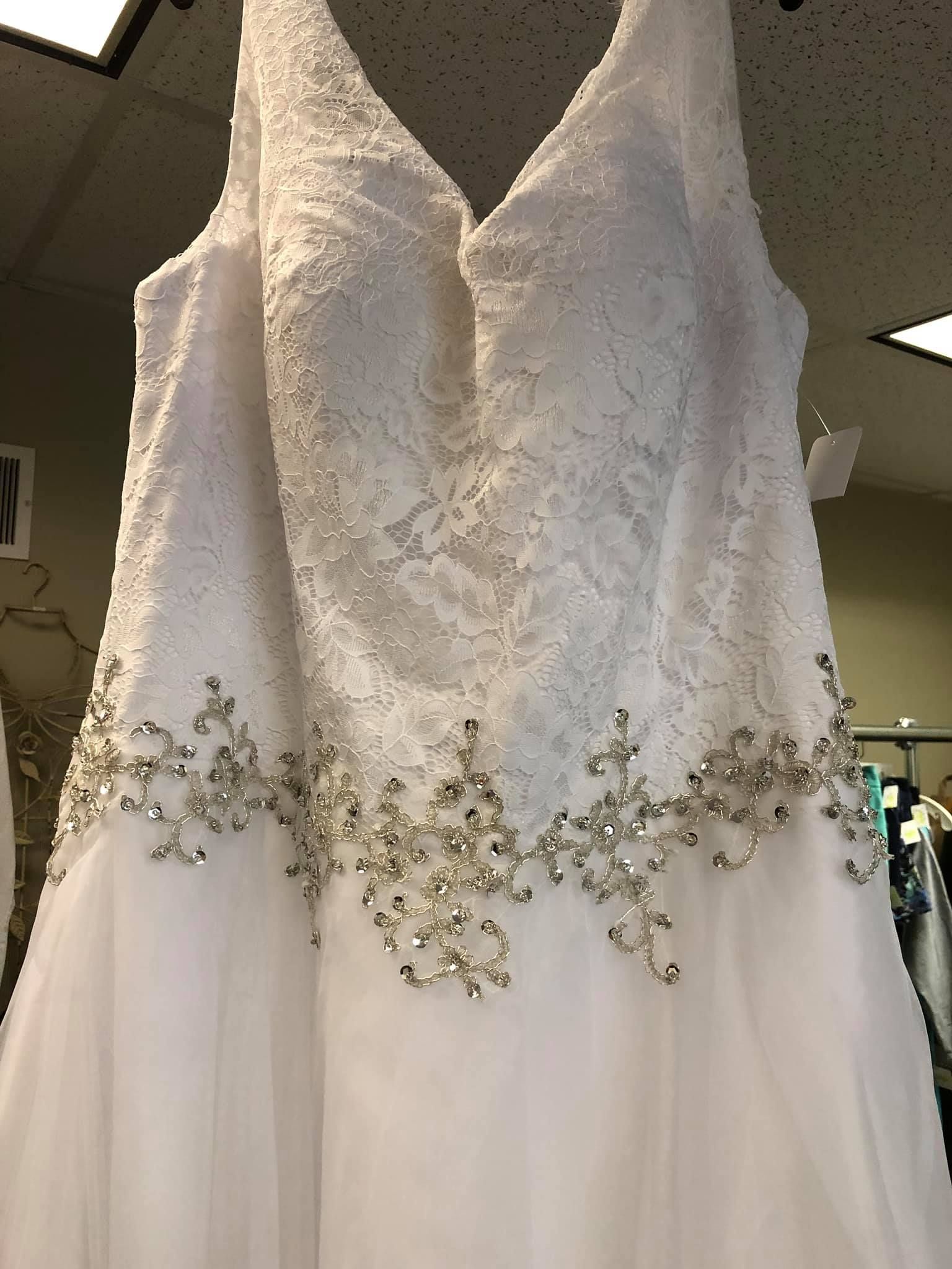 A mannequin wearing a tuxedo and hat is in a store