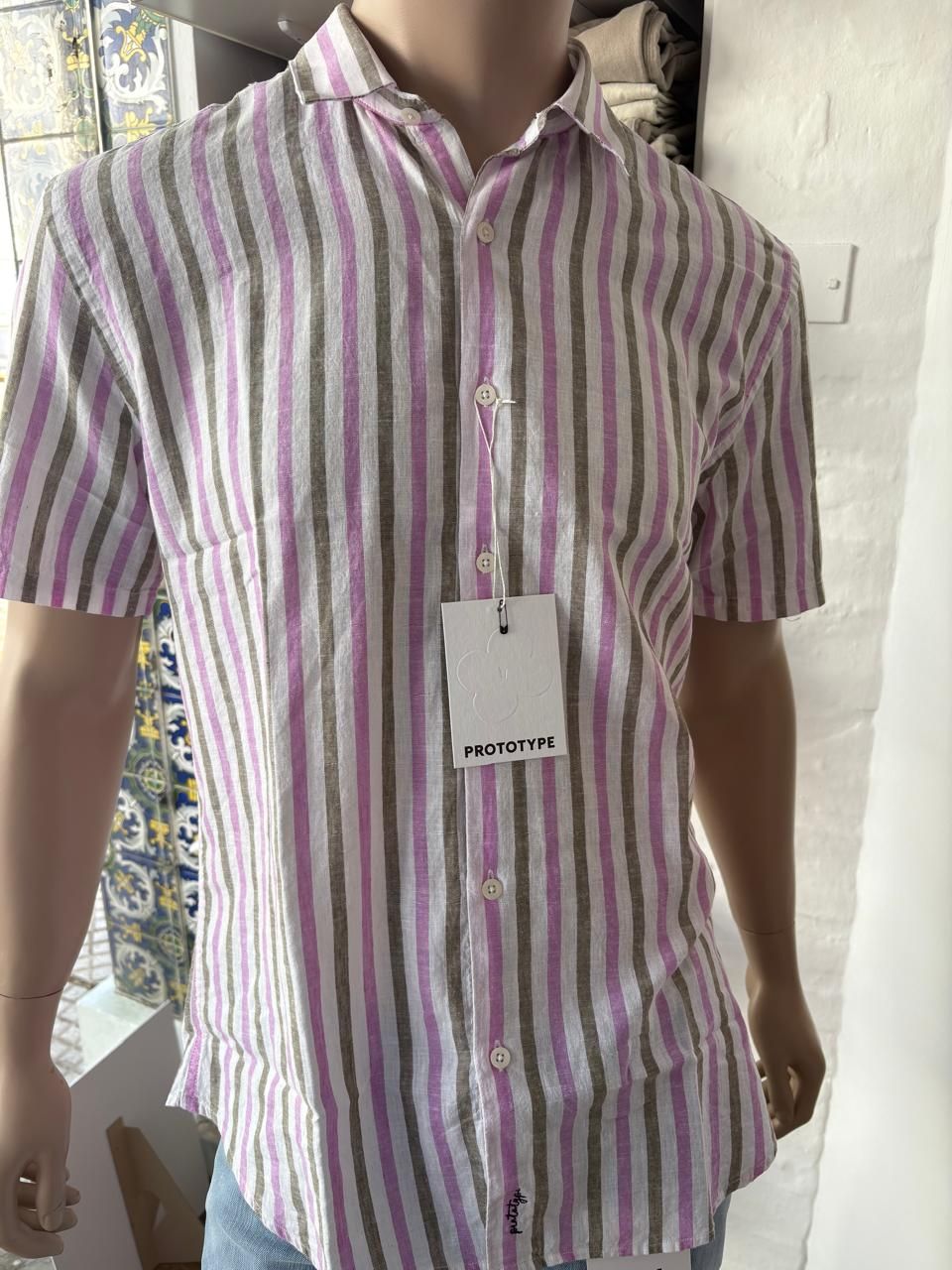 Maniquí con camisa de manga corta a rayas de color rosa y verde.