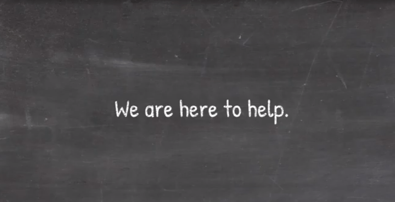 A blackboard with the words we are here to help written on it