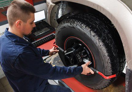 Tire Repair — Mechanic Doing Tire Measurement In Blackstone, M