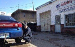 Auto Repair — Mechanic Checking The  Blue Car Tire In Blackstone, MA
