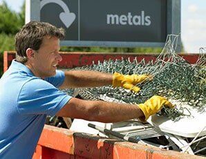 Mna Holding a Scrap Metal — Scrap Yard in Millbury, MA