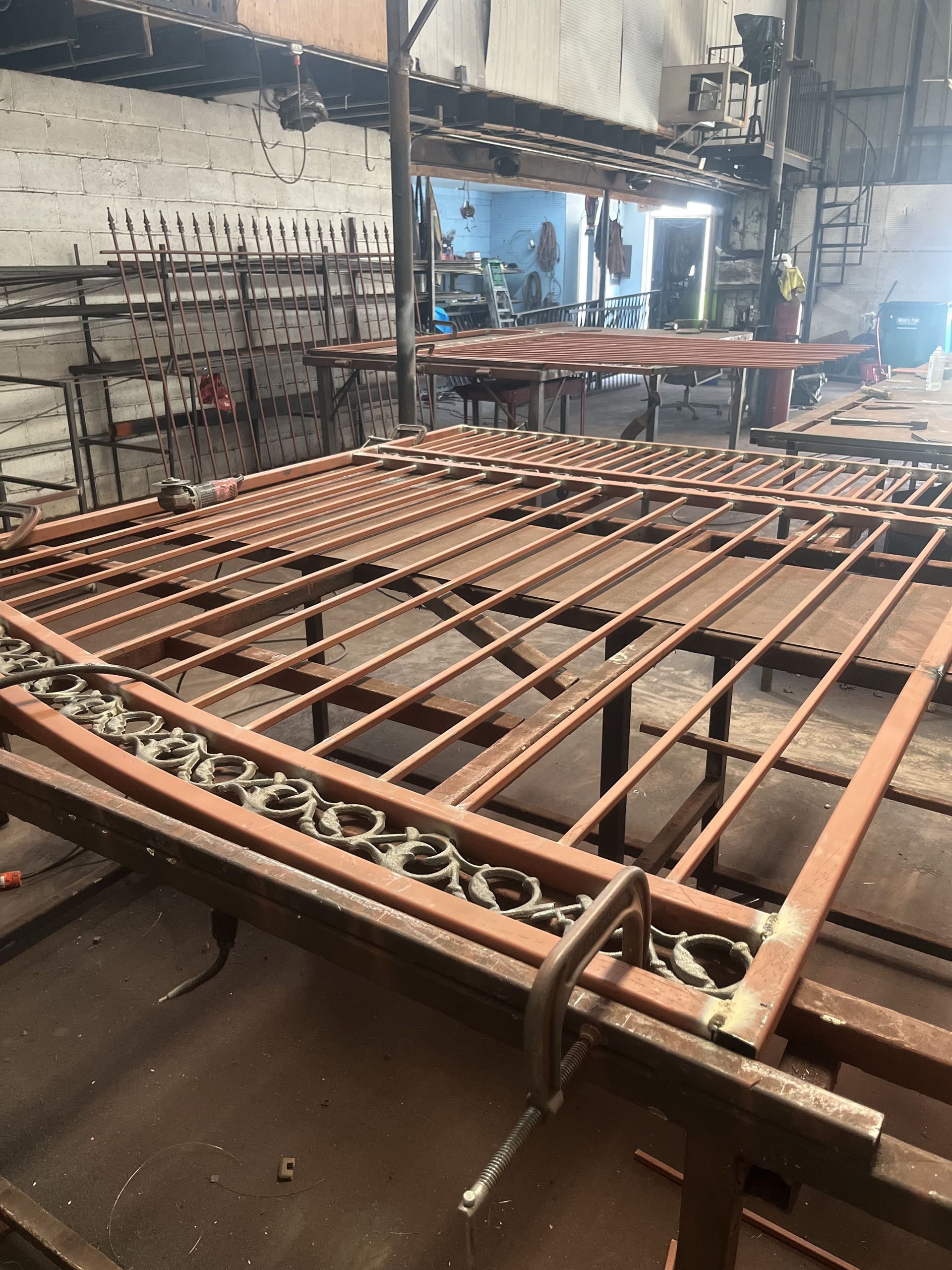 A large piece of metal is sitting on top of a wooden table in a factory.