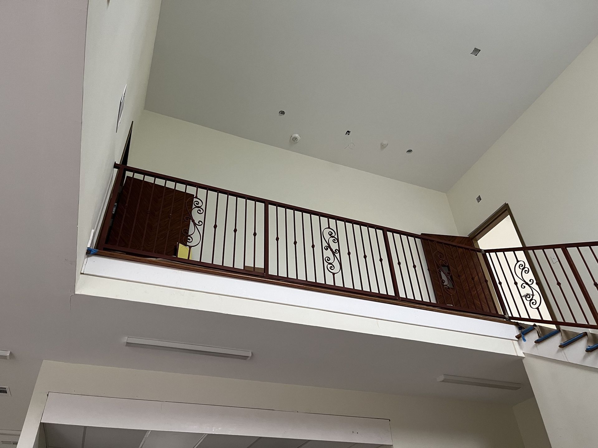 A balcony with a railing and stairs in a building.