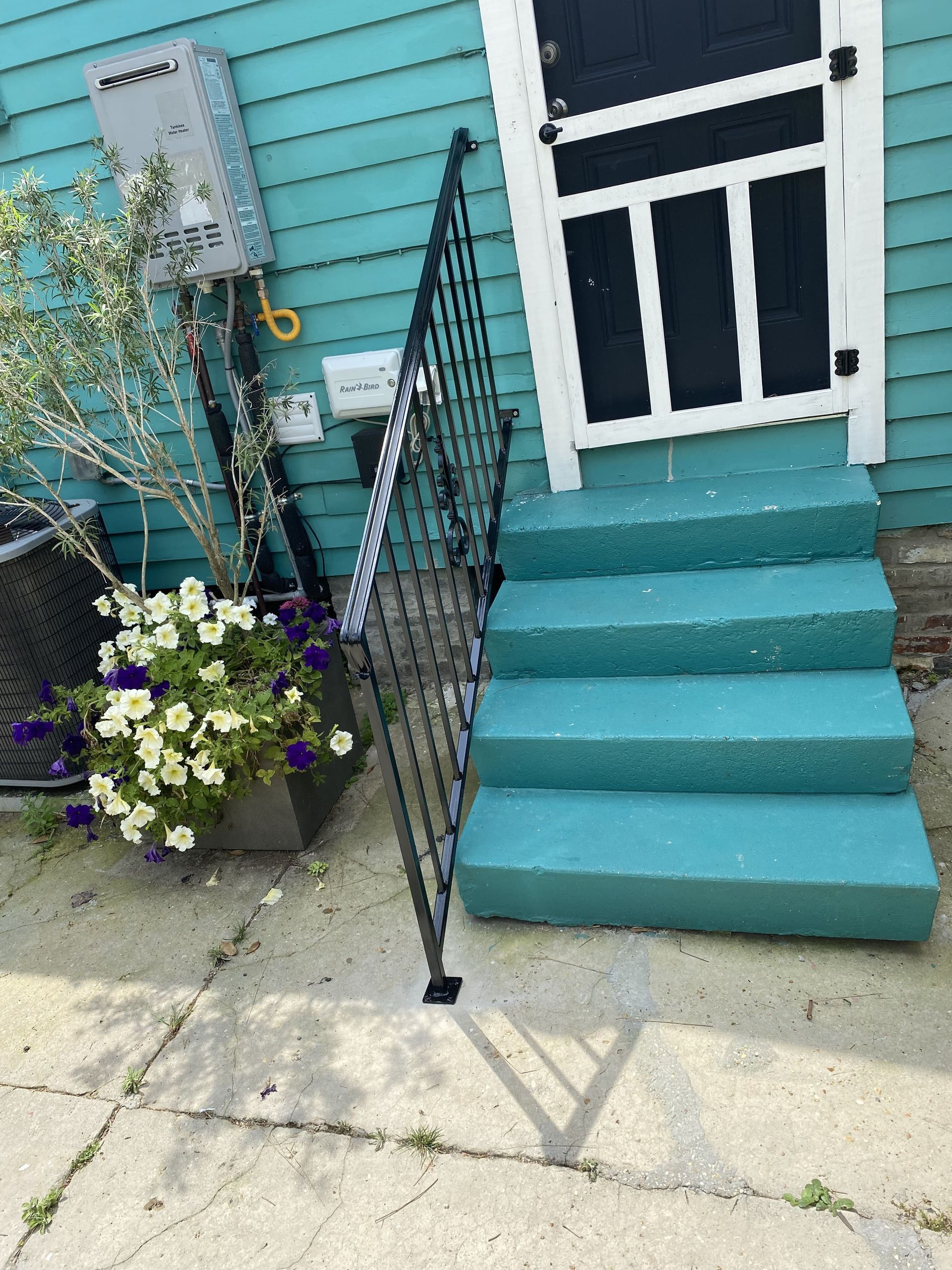 A blue house with stairs leading up to it
