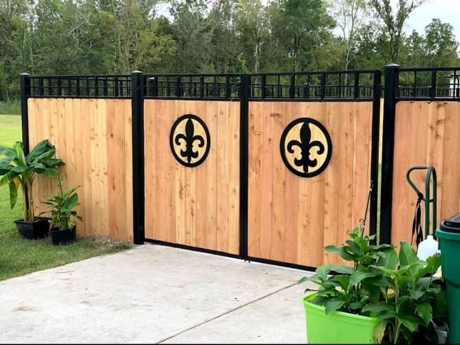 A wooden fence with a fleur de lis design on it