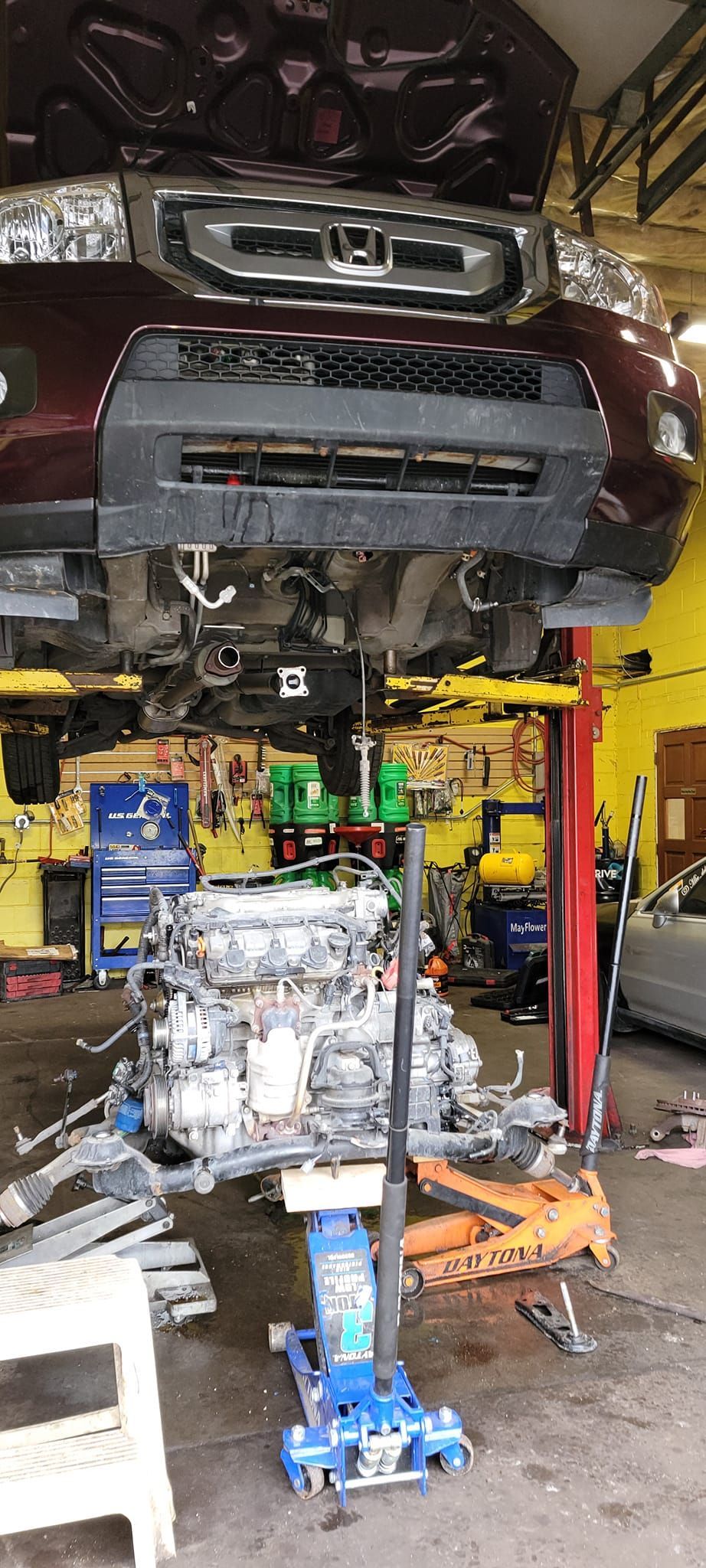 A car engine is being worked on in a garage.