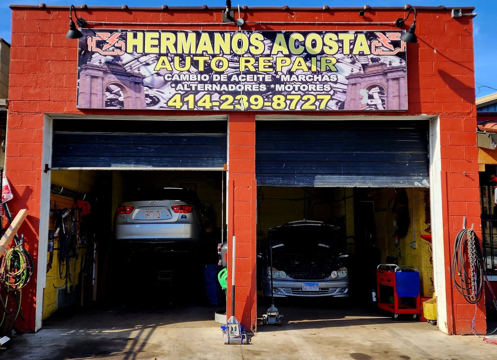 A garage with a sign that says hermanos acosta auto repair