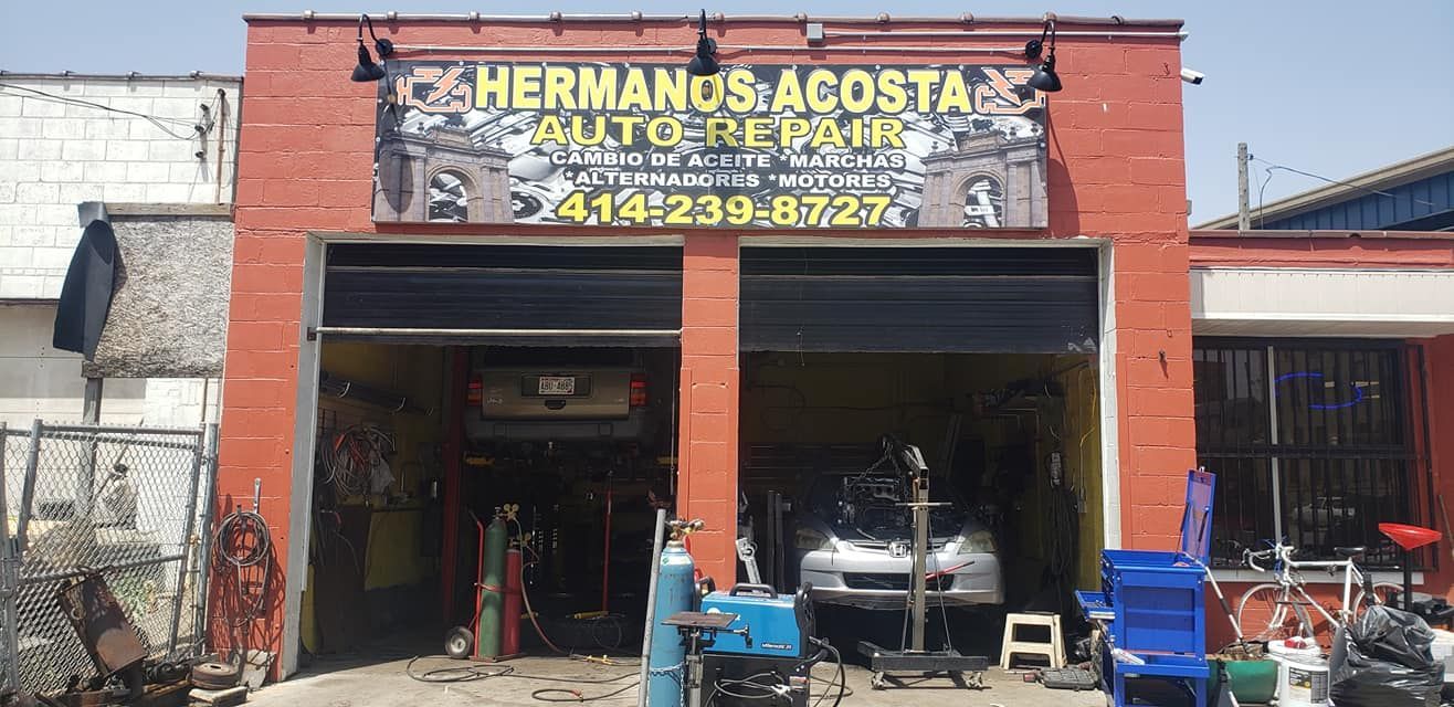 A garage with a sign that says hermanos acosta auto repair