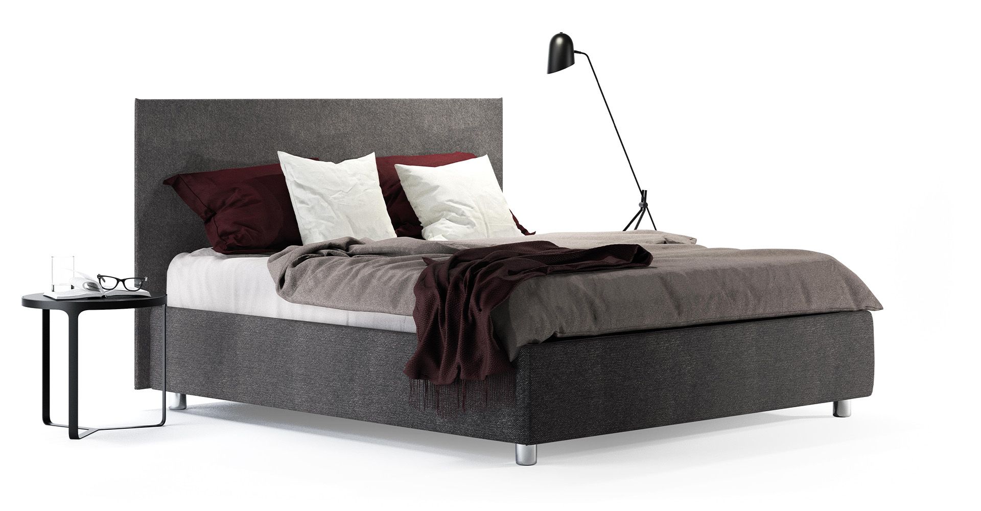 Un letto con una lampada sul lato