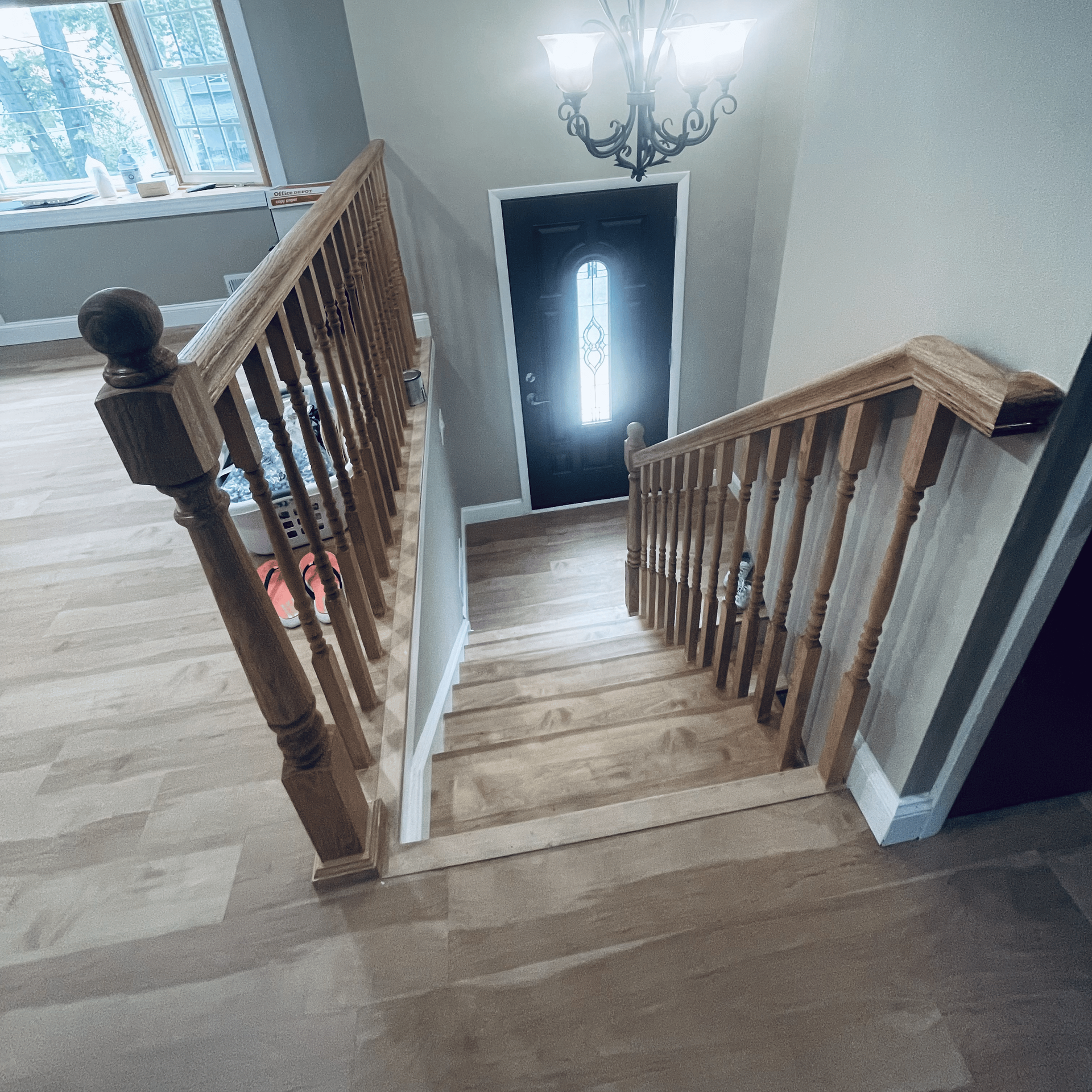 A wooden staircase leading up to a door in a house.