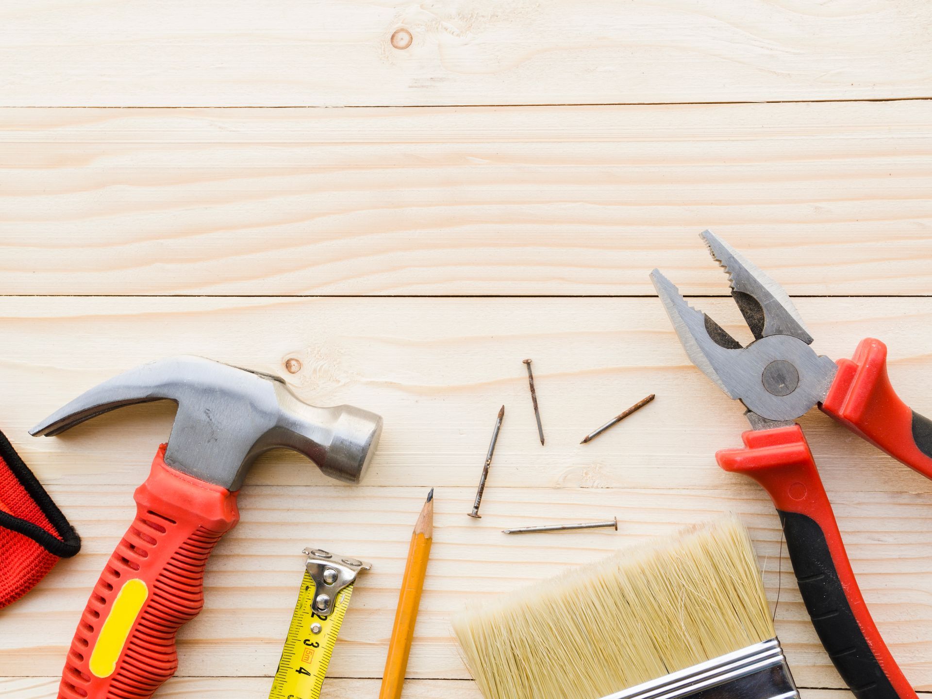 A person is using a drill on a wooden wall