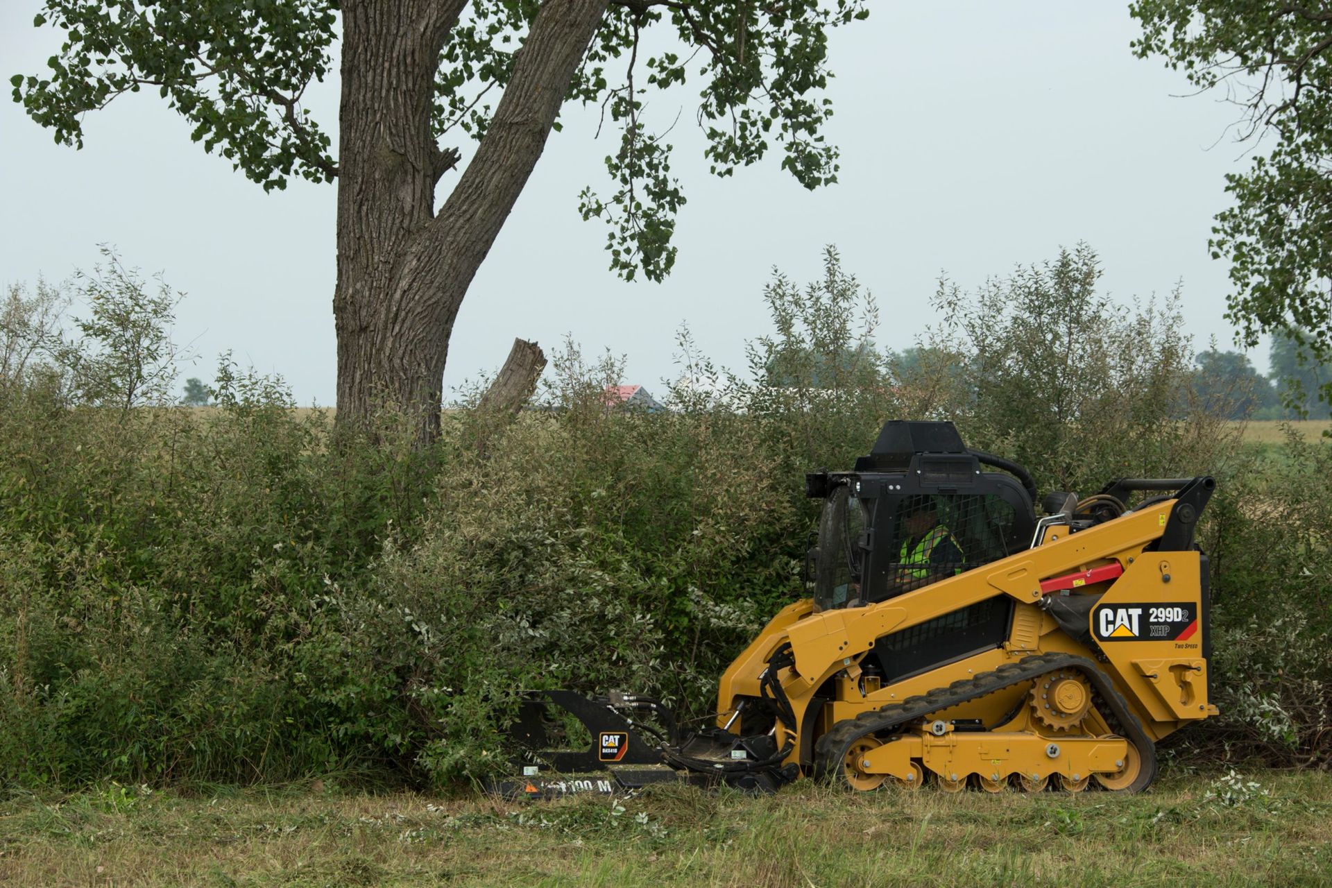 Hands holding a model house, discussing blueprints. Two people with pens, one pointing.