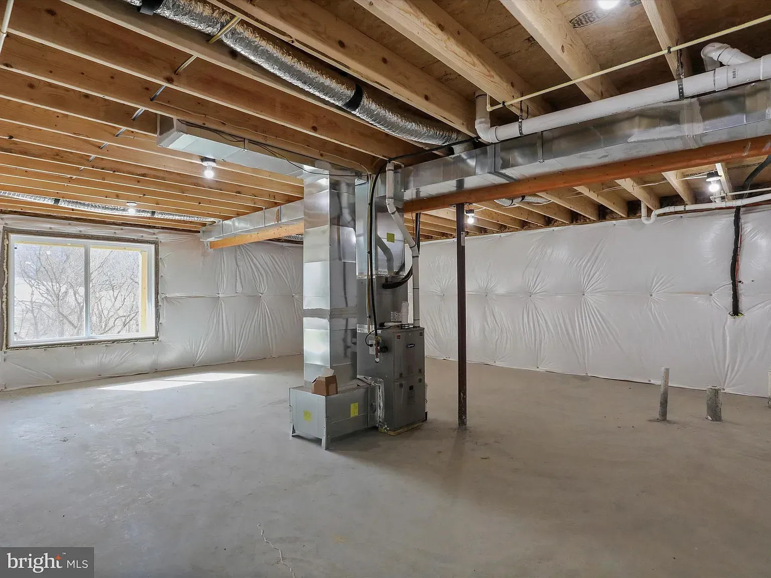 Person uses a teal circular saw to cut a white piece of siding outdoors.