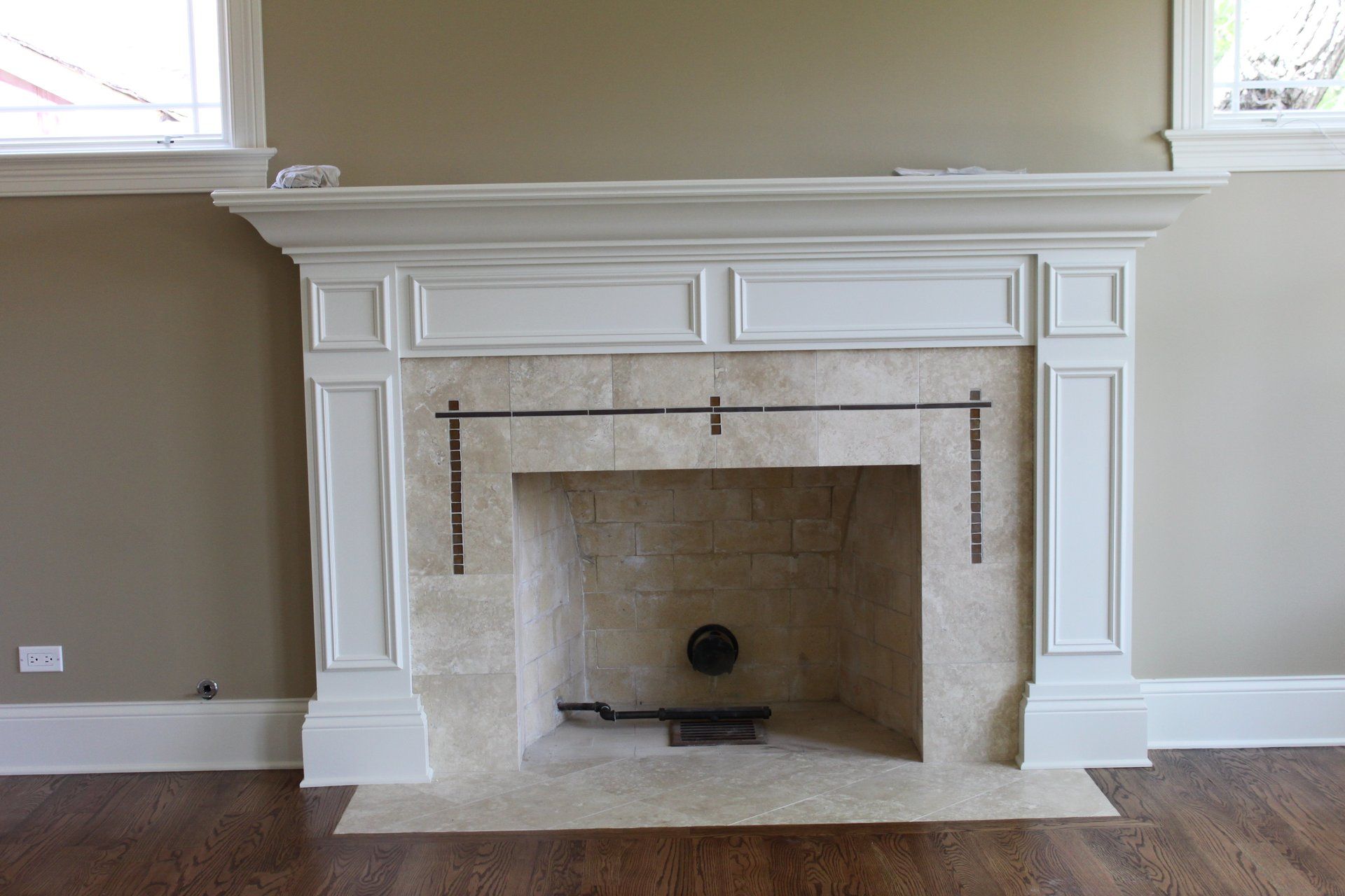 A fireplace with a white mantle in a living room.